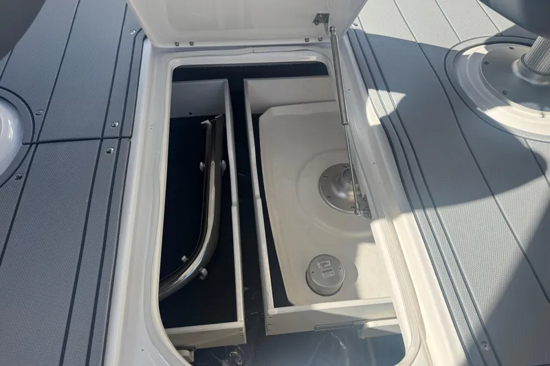 Slide: The Image of Storage compartment on 2026 Chaparral SSX 30 boat deck, open with visible interior. - 15