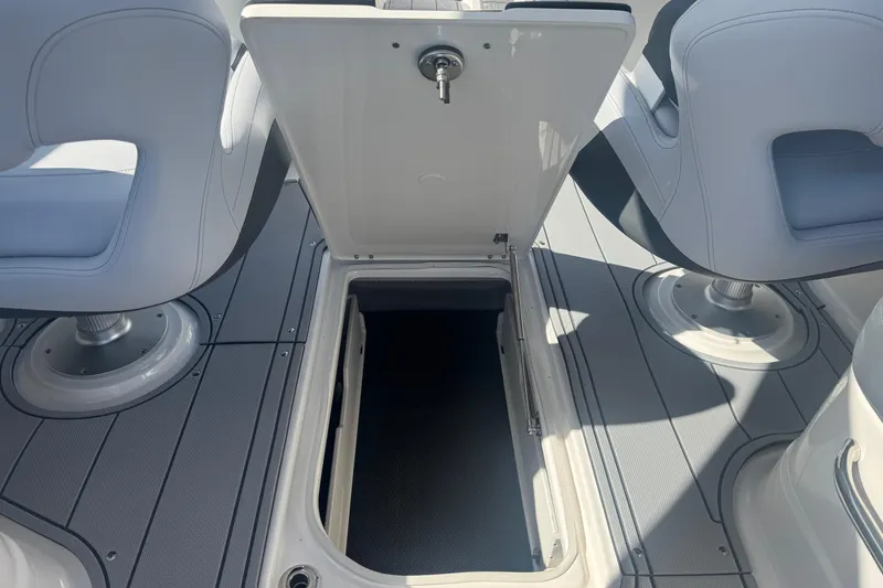 Slide: The Image of 2026 Chaparral SSX 30 boat interior with open storage compartment and seating. - 17