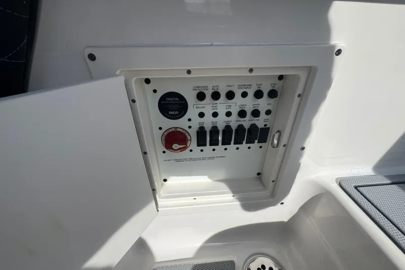 Slide: The Image of Control panel of 2026 Chaparral SSX 30 boat with switches and digital display. - 2