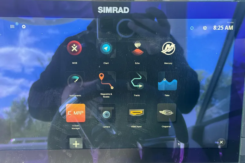 Slide: The Image of Simrad marine display interface on 2026 Chaparral SSX 30 boat, showing navigation and control apps. - 21