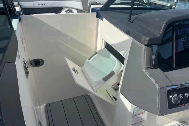 Slide: The Image of 2026 Chaparral SSX 30 boat interior with storage compartment and control panel. - 27