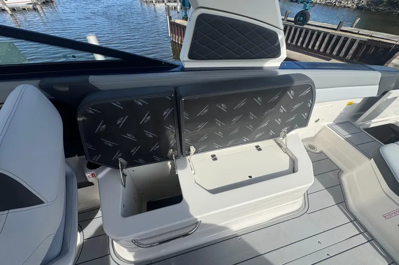 Slide: The Image of 2026 Chaparral SSX 30 boat interior with open storage compartment by the water. - 28