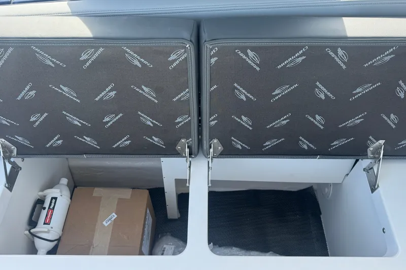 Slide: The Image of Storage compartments in a 2026 Chaparral SSX 30 boat, featuring branded upholstery. - 29