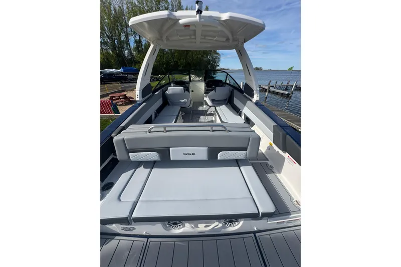 Slide: The Image of 2026 Chaparral SSX 30 boat interior with spacious seating and sleek design by the water. - 34
