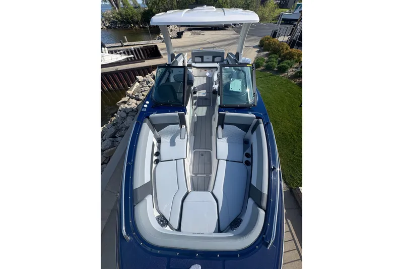 Slide: The Image of 2026 Chaparral SSX 30 boat with spacious seating and sleek design, docked by the water. - 7