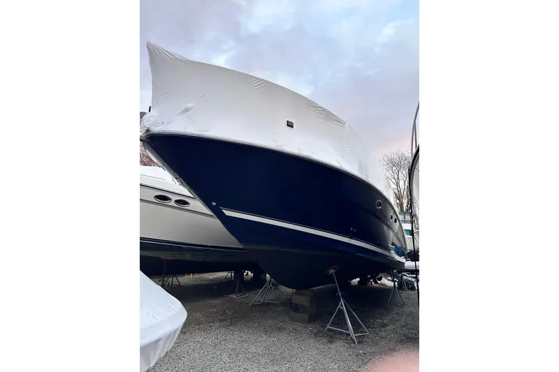 Slide: The Image of 2005 Sea Ray 390 Sundancer boat covered and stored on stands. - 4