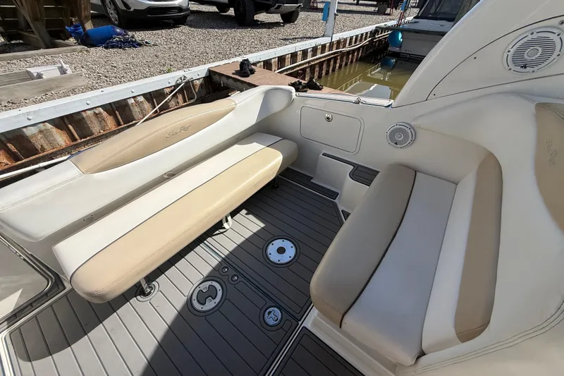 Slide: The Image of 2009 Sea Ray Sundancer 280 interior with beige seating and gray flooring. - 2