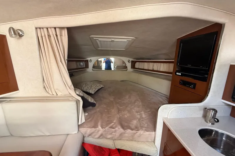 Slide: The Image of Interior cabin of 2009 Sea Ray Sundancer 280 with bed, TV, and kitchenette. - 9