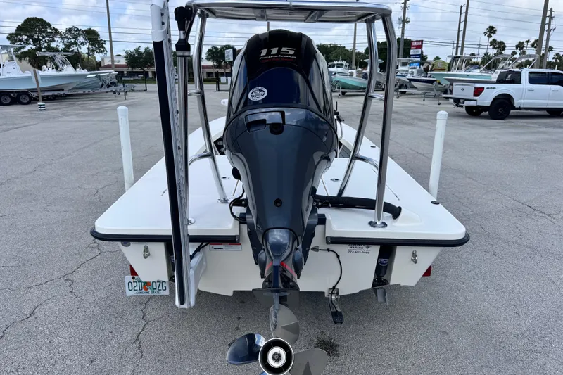 Slide: The Image of 2022 Maverick 18 HPX-V boat with 115 HP engine, parked in a marina lot. - 11