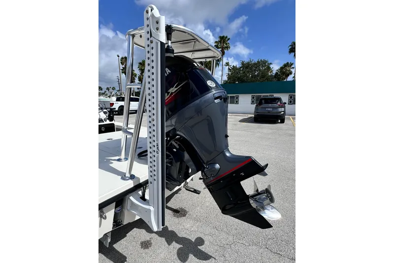 Slide: The Image of 2022 Maverick 18 HPX-V boat with outboard motor in parking lot. - 18
