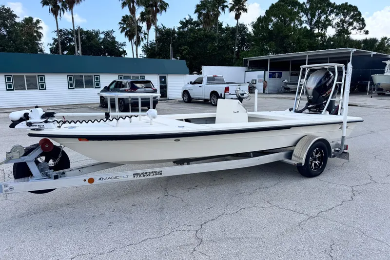 The Image of 2022 Maverick 18 HPX-V boat on trailer, parked outdoors near palm trees. - 8