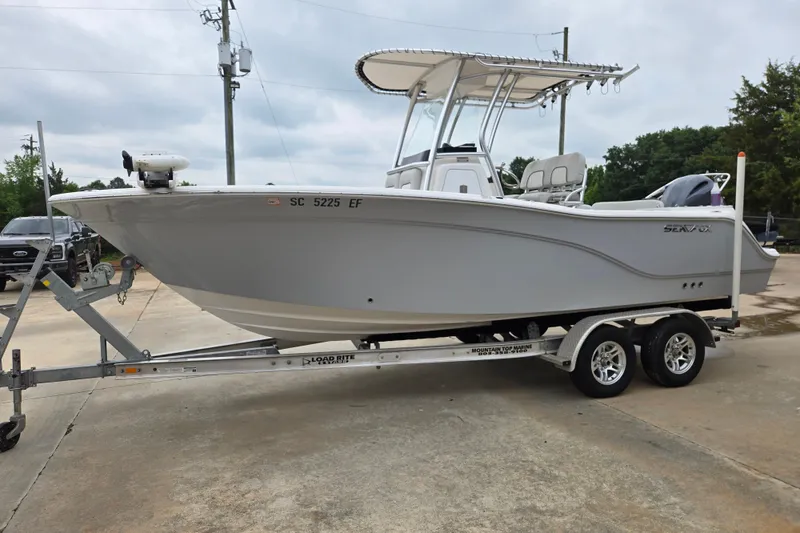 The Image of 2023 Sea Fox 228 Commander boat on trailer, parked outdoors. - 1