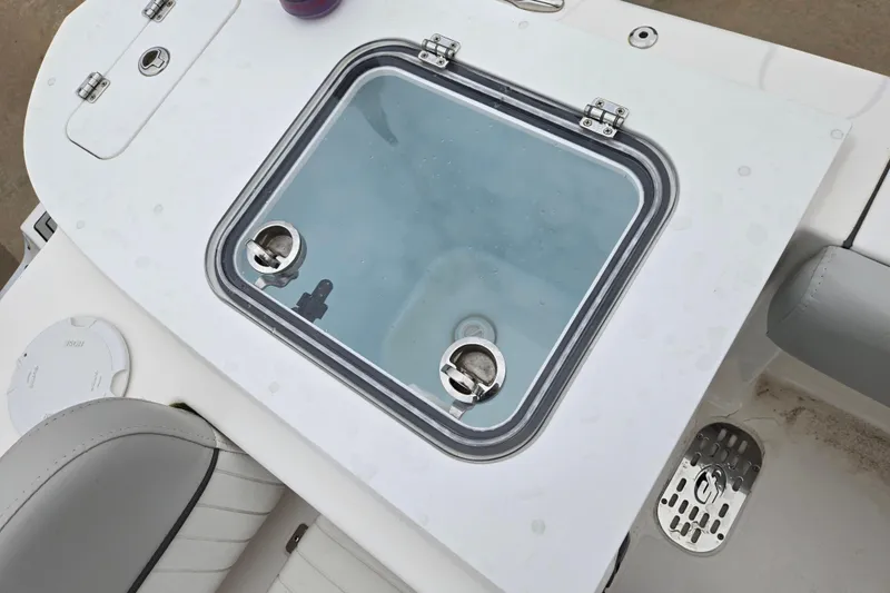 Slide: The Image of Livewell on 2023 Sea Fox 228 Commander boat, featuring secure latches and clear lid. - 12