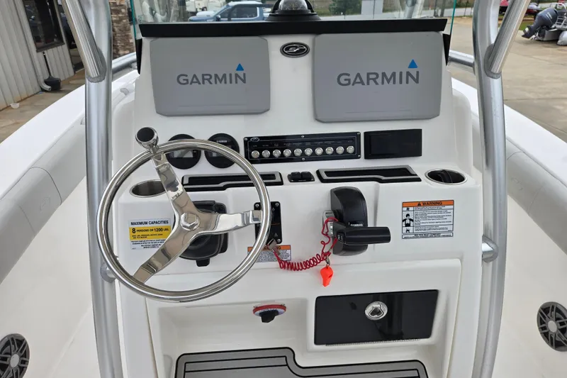 Slide: The Image of 2023 Sea Fox 228 Commander boat dashboard with Garmin displays and steering wheel. - 13