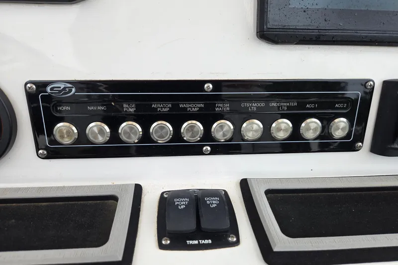 Slide: The Image of Control panel of a 2023 Sea Fox 228 Commander boat with labeled switches. - 18