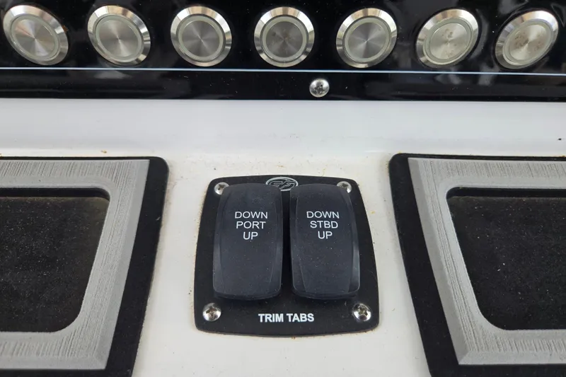 Slide: The Image of Control panel of 2023 Sea Fox 228 Commander boat with trim tab switches. - 19