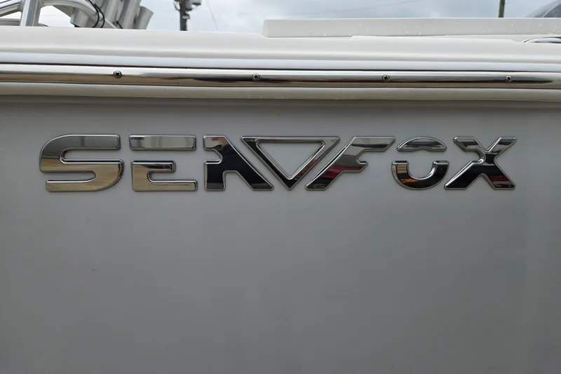 Slide: The Image of Sea Fox 228 Commander 2023 logo on boat exterior, chrome lettering. - 22