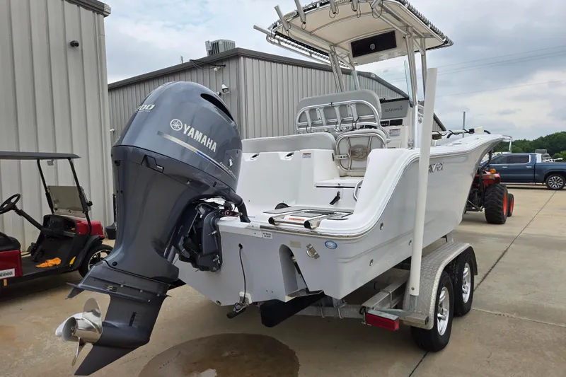 Slide: The Image of 2023 Sea Fox 228 Commander boat with Yamaha engine on a trailer, parked outdoors. - 24