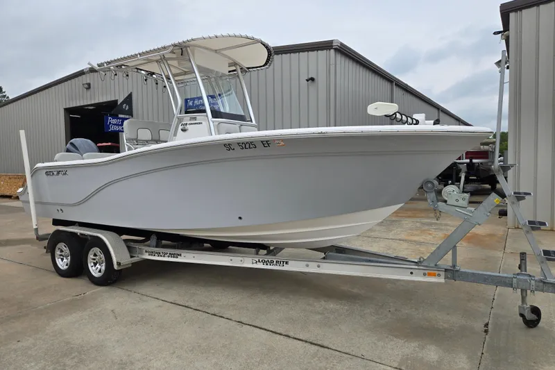 Slide: The Image of 2023 Sea Fox 228 Commander boat on trailer outside a metal building. - 3
