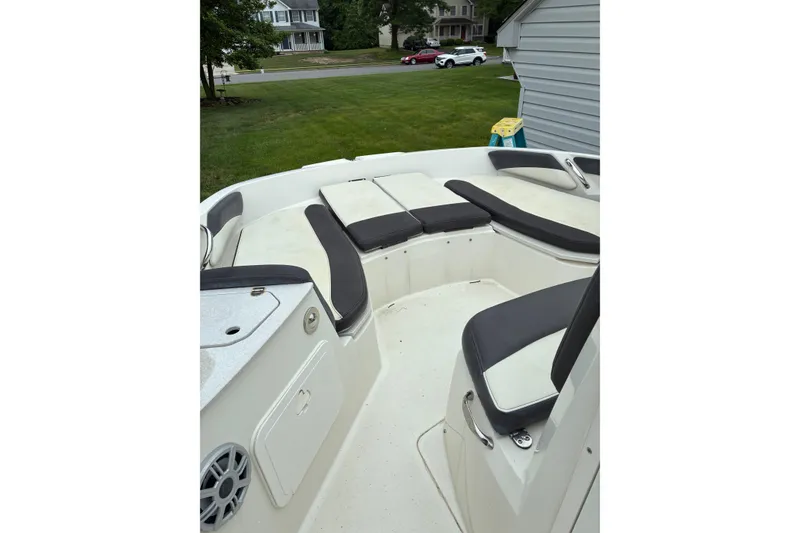 Slide: The Image of 2017 Stingray 206 CC boat interior with cushioned seating and storage compartments. - 5