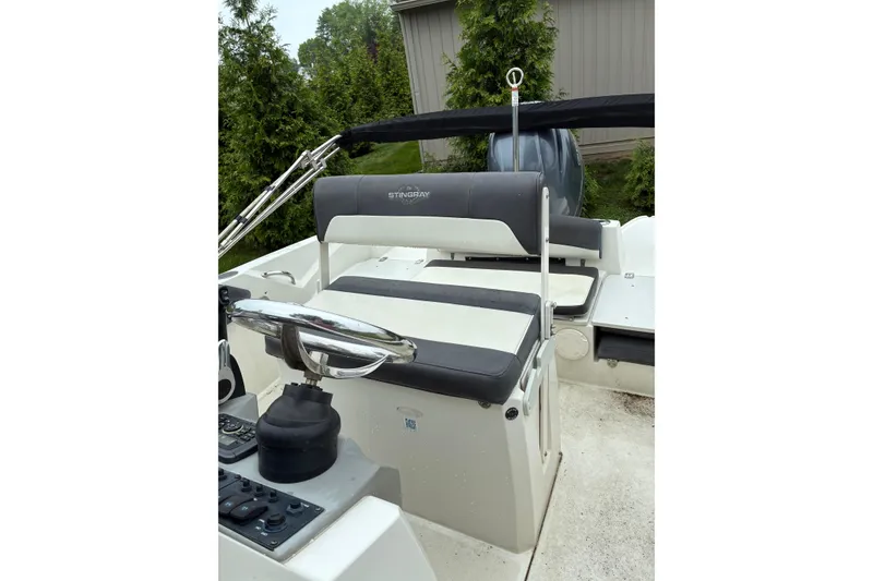 Slide: The Image of 2017 Stingray 206 CC boat interior with steering wheel and seating. - 7