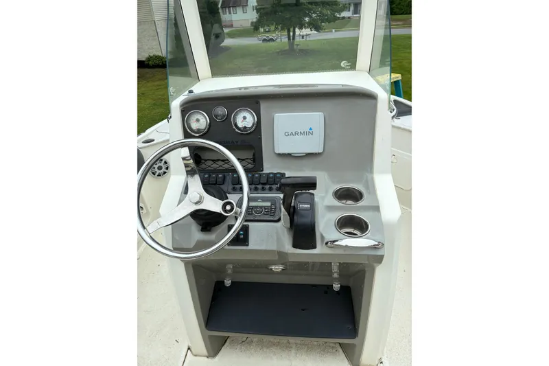 Slide: The Image of 2017 Stingray 206 CC boat dashboard with Garmin navigation system and steering wheel. - 8