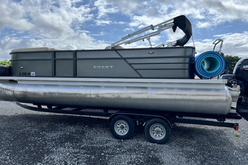 Slide: The Image of 2016 Crest I 220 pontoon boat on trailer under cloudy sky. - 4