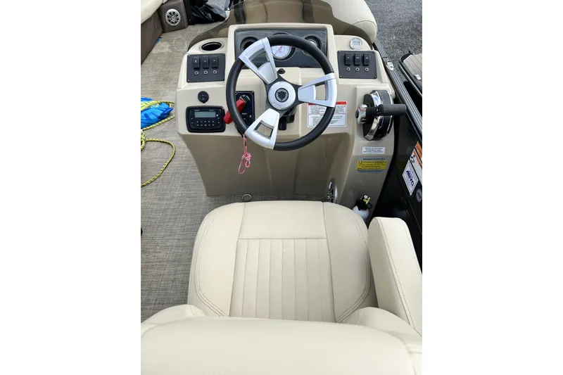 Slide: The Image of 2016 Crest I 220 boat helm with steering wheel and control panel. - 5