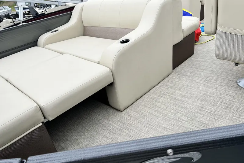 Slide: The Image of 2016 Crest I 220 boat interior with beige seating and textured flooring. - 8