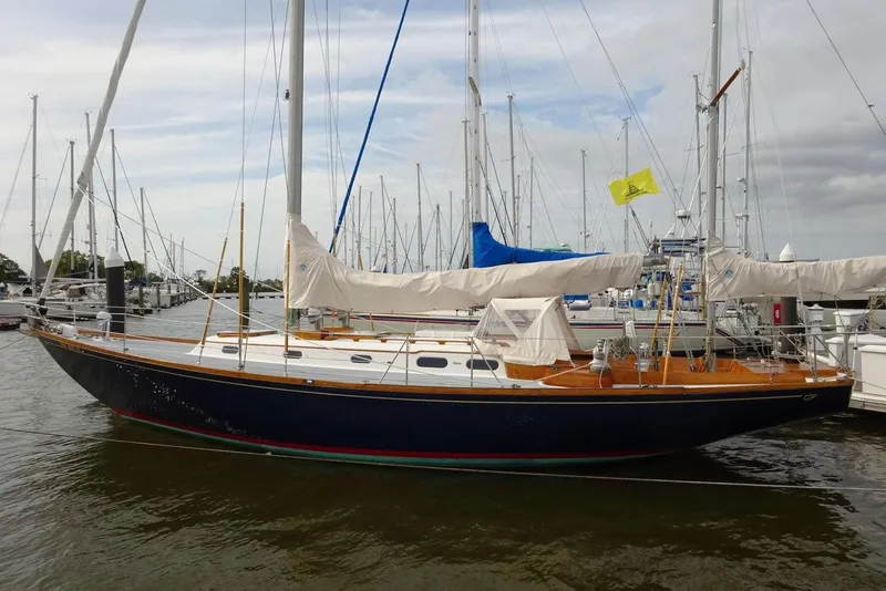 The Image of 1964 Hinkley Bermuda 40 sailboat docked at marina, featuring classic design and wooden deck. - 0