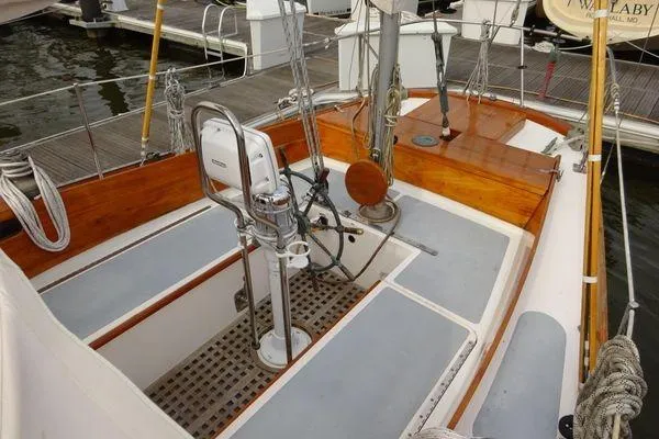 Slide: The Image of 1964 Hinkley Bermuda 40 sailboat cockpit with wooden accents and steering wheel. - 10