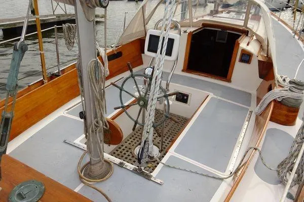 Slide: The Image of 1964 Hinkley Bermuda 40 sailboat cockpit with wooden accents and steering wheel. - 12