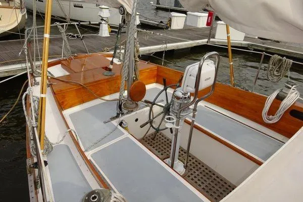 Slide: The Image of 1964 Hinkley Bermuda 40 sailboat cockpit with wooden accents and steering wheel. - 13