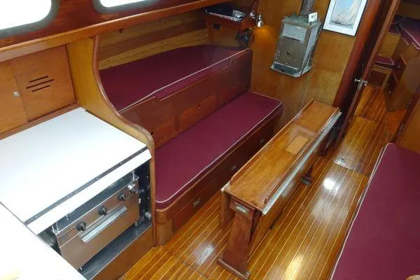 Slide: The Image of Interior of 1964 Hinkley Bermuda 40 sailboat with wooden furnishings and maroon seating. - 15