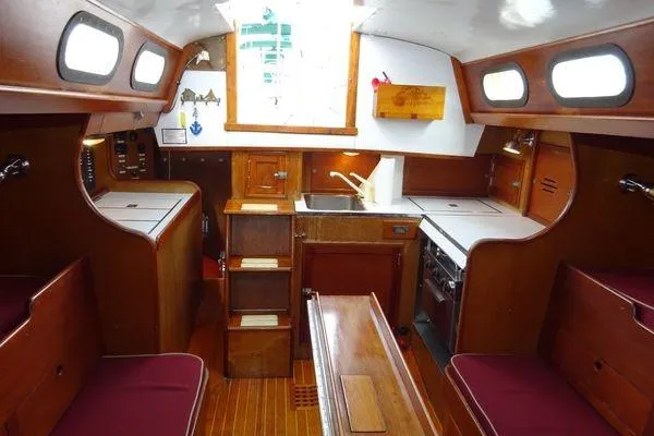 Slide: The Image of Interior of a 1964 Hinkley Bermuda 40 sailboat with wooden cabinetry and compact kitchen. - 20