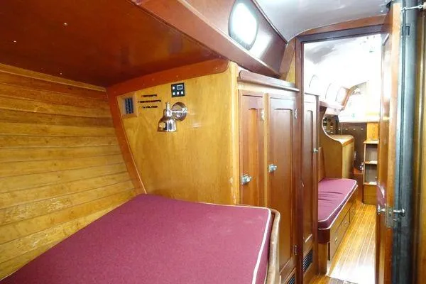 Slide: The Image of Interior of 1964 Hinkley Bermuda 40 sailboat with wooden furnishings and maroon cushions. - 27