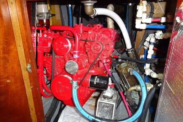 Slide: The Image of Engine compartment of a 1964 Hinkley Bermuda 40 sailboat, featuring a red engine. - 29