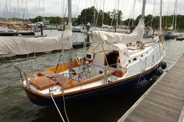 Slide: The Image of 1964 Hinkley Bermuda 40 sailboat docked at a marina, showcasing classic design and craftsmanship. - 3
