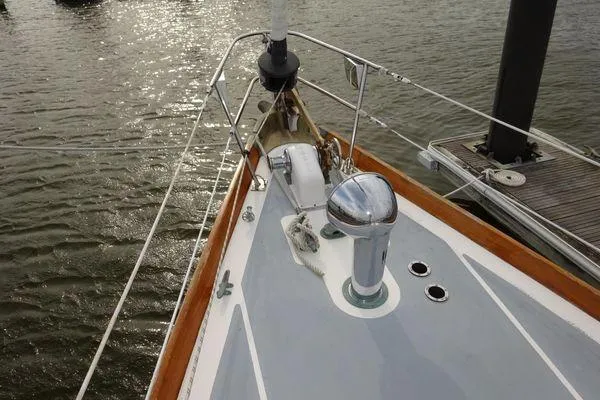 Slide: The Image of Bow of a 1964 Hinkley Bermuda 40 sailboat docked on calm water. - 7