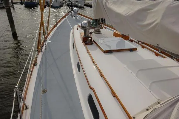 Slide: The Image of Sailboat deck of 1964 Hinkley Bermuda 40, featuring classic wooden trim and sleek design. - 9