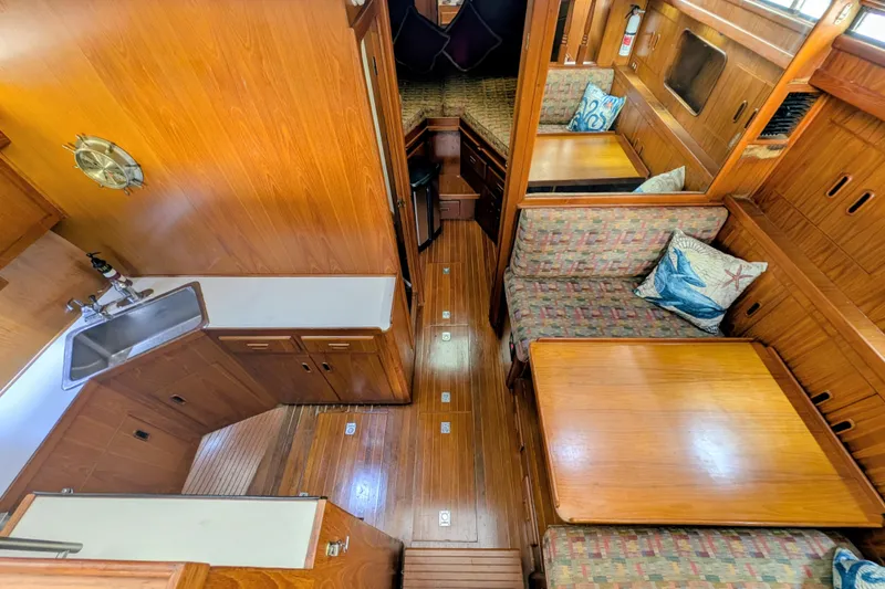 Slide: The Image of Interior of 1989 President 37 Double Cabin yacht with wood finish and cozy seating area. - 10