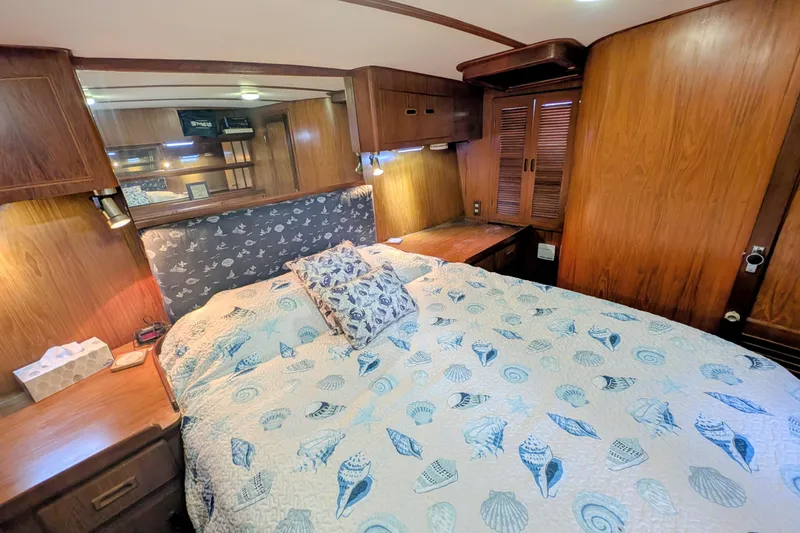 Slide: The Image of Cozy bedroom in 1989 President 37 Double Cabin yacht with nautical-themed bedding. - 18