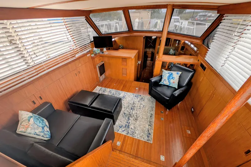 Slide: The Image of 1989 President 37 Double Cabin interior with leather seating, wooden paneling, and nautical decor. - 5
