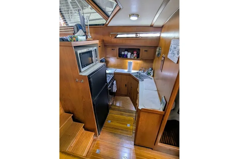 Slide: The Image of 1989 President 37 Double Cabin yacht galley with wood cabinetry and modern appliances. - 8