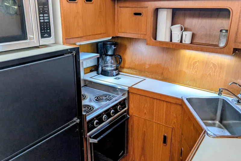 Slide: The Image of 1989 President 37 Double Cabin kitchen with stove, sink, and wooden cabinetry. - 9