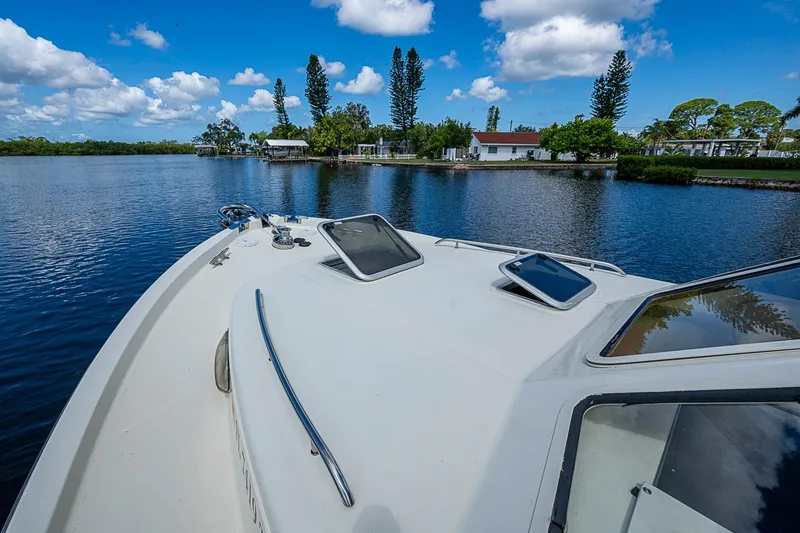 Slide: The Image of Bow view of 2002 True North 38 boat on a serene lake with blue skies. - 11