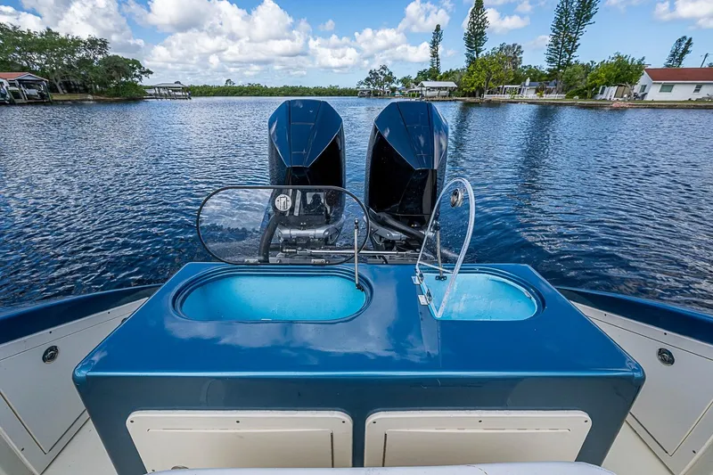 Slide: The Image of 2002 True North 38 boat with dual engines on a serene lake. - 16
