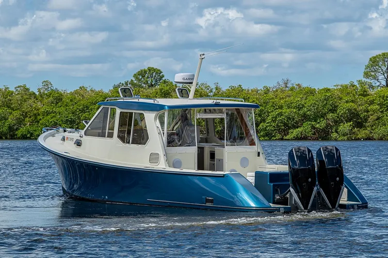 Slide: The Image of True North 38 boat from 2002 cruising on a scenic waterway. - 2