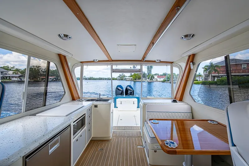 Slide: The Image of Interior of 2002 True North 38 boat with lake view, featuring modern kitchen and seating area. - 21
