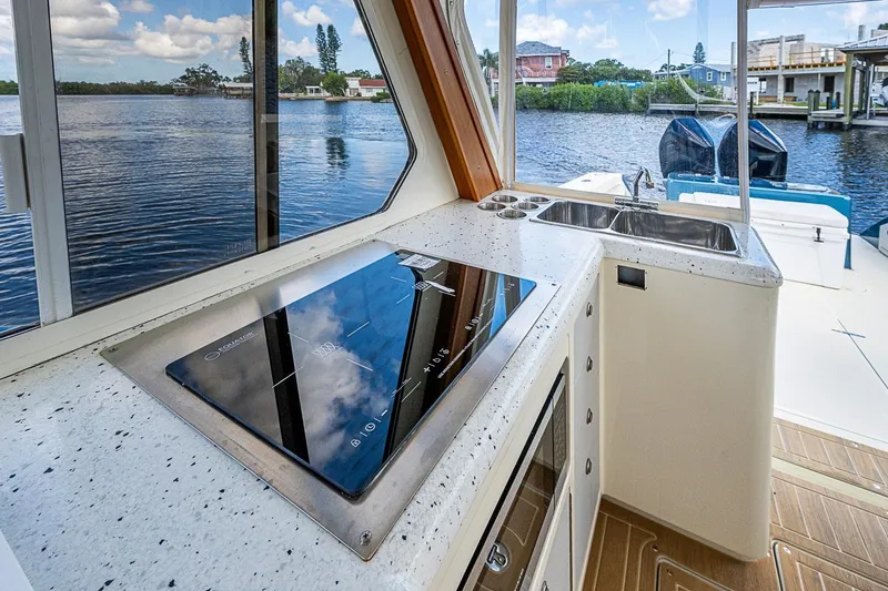 Slide: The Image of Modern kitchen area on a 2002 True North 38 boat with scenic water view. - 23